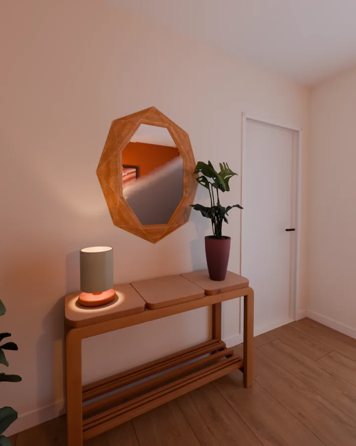 Aparador de madeira com luminária de mesa acesa e planta, espelho de moldura de madeira facetada centralizado acima dele refletindo a parede terracota, porta branca ao lado