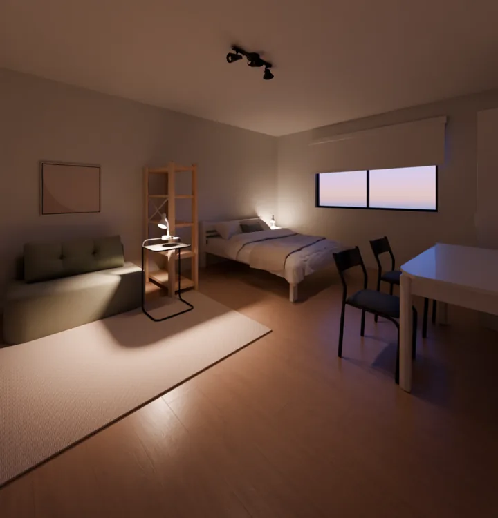 Kitnet ao anoitecer vista da porta de entrada: sofá verde sobre tapete claro com um quadro acima, estante vazada de madeira com a mesa lateral e o abajur aceso, a cama de casal branca atrás da estante, a janela com a persiana branca meio abaixada e, à direita, duas cadeiras pretas na mesa branca
